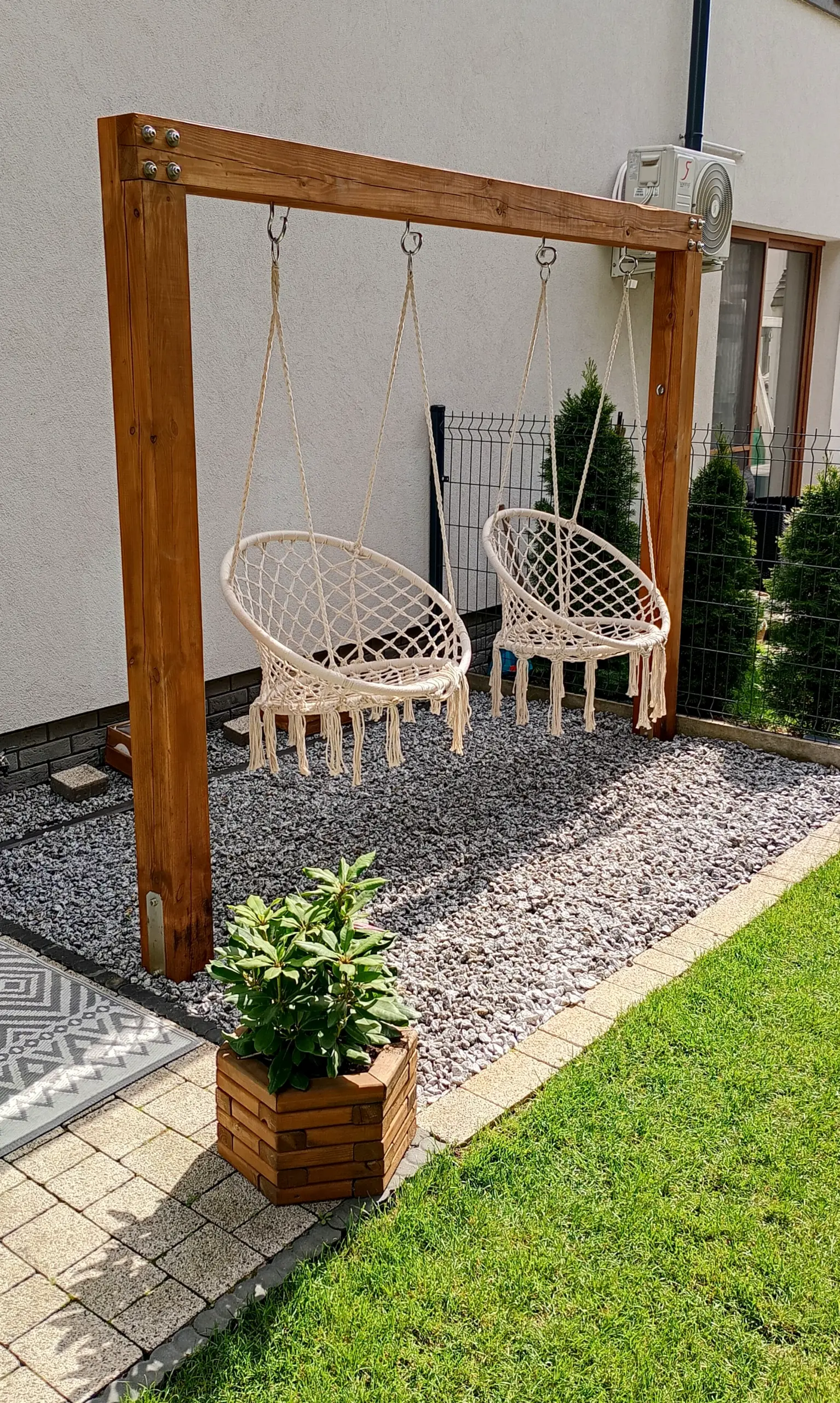 Colorful soft sofa anchors the garden edge with clarity, giving the view a mood that feels simple yet expressive.