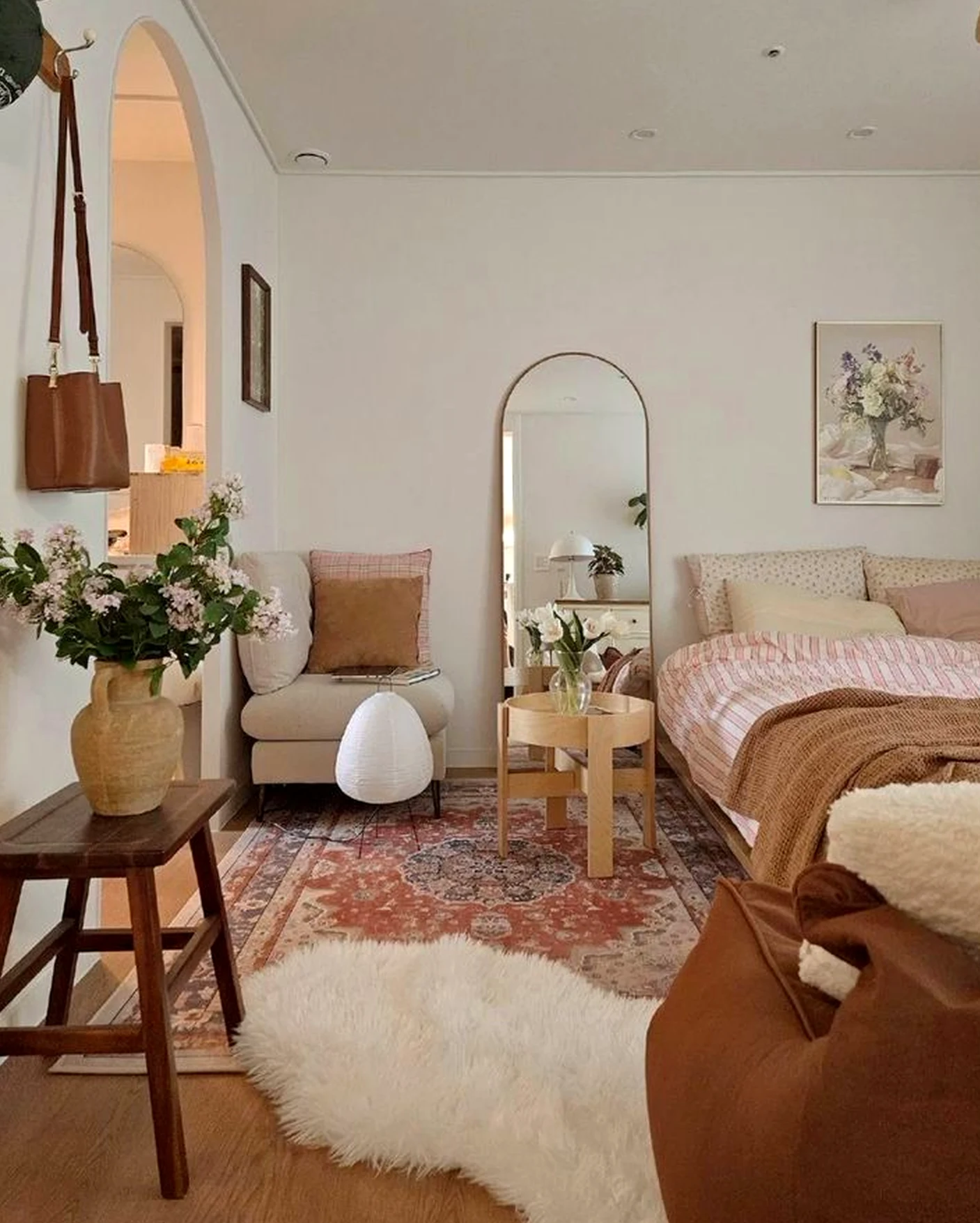 Layered arched doorway draws attention to warmth while the wall stays simple yet expressive.