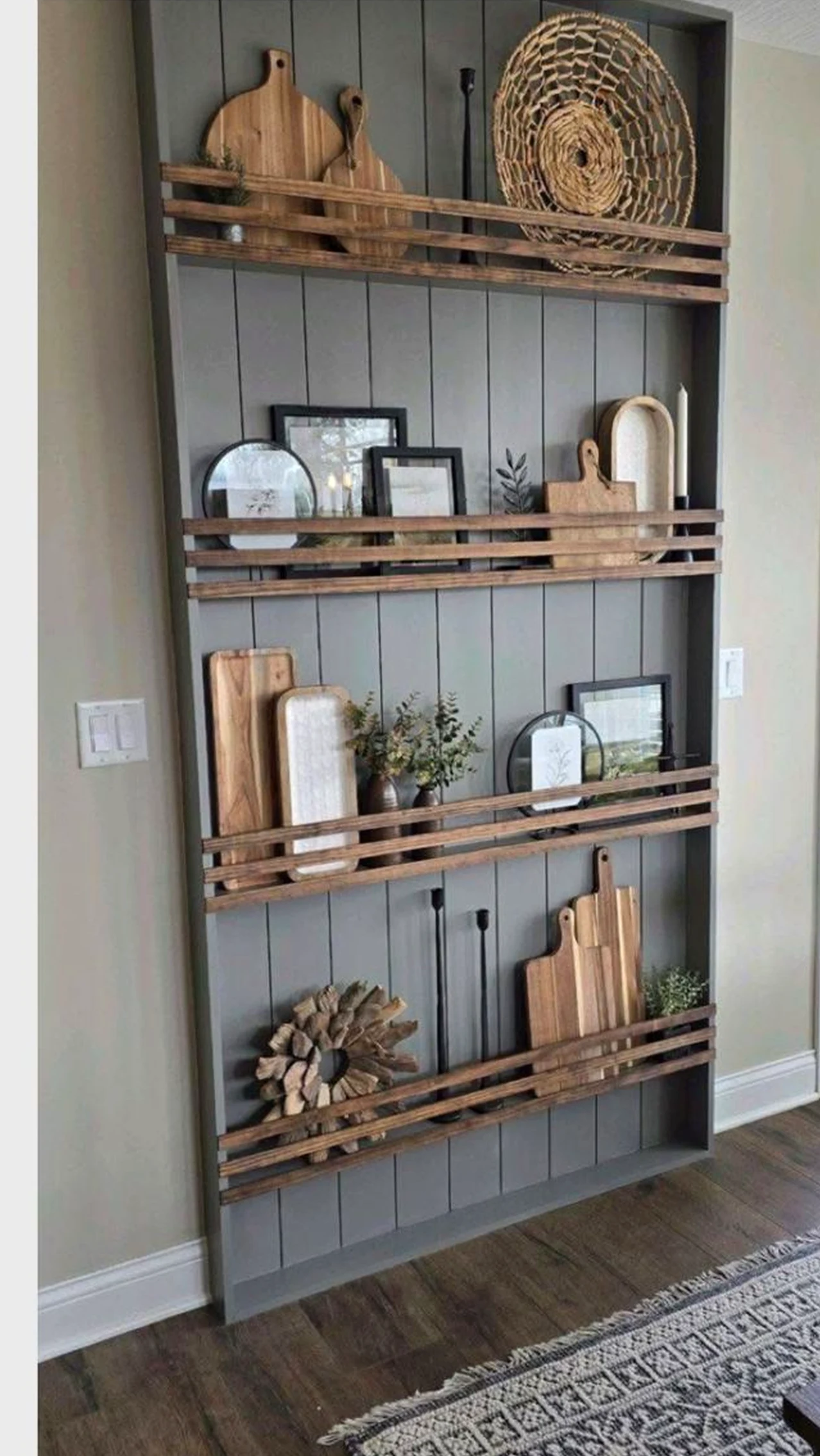 Leafy vase display brings detail to the room, creating a mood that feels simple yet expressive.